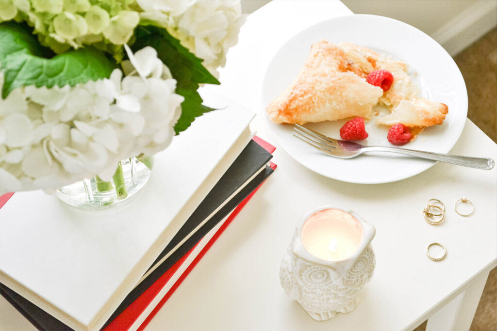 Candle and Snack with Books on a table