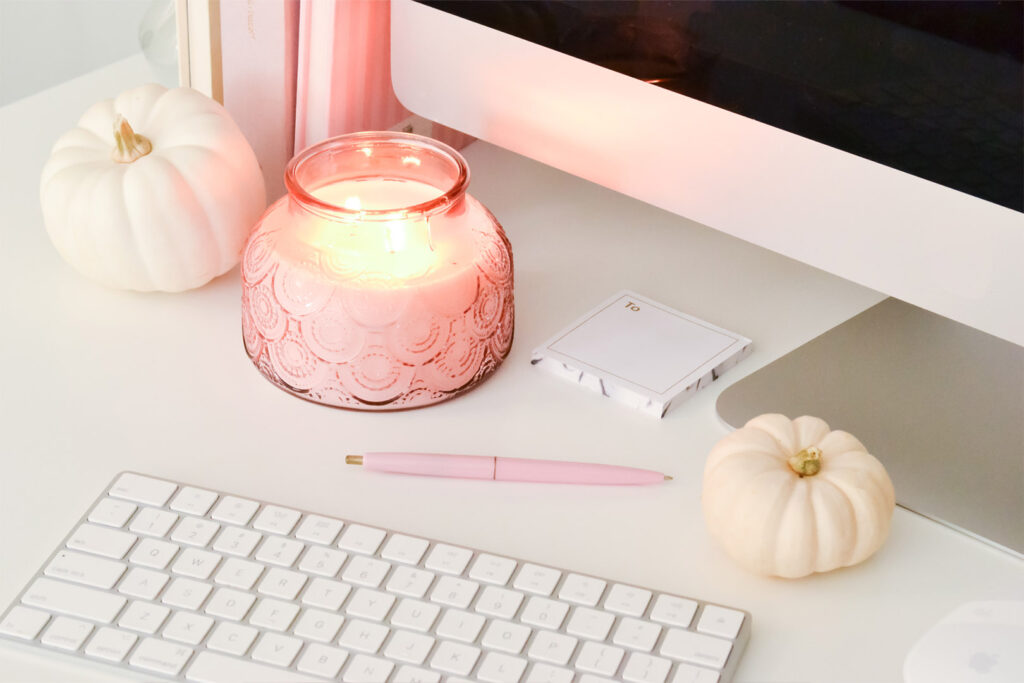 Candle by Computer and Keyboard on Desk