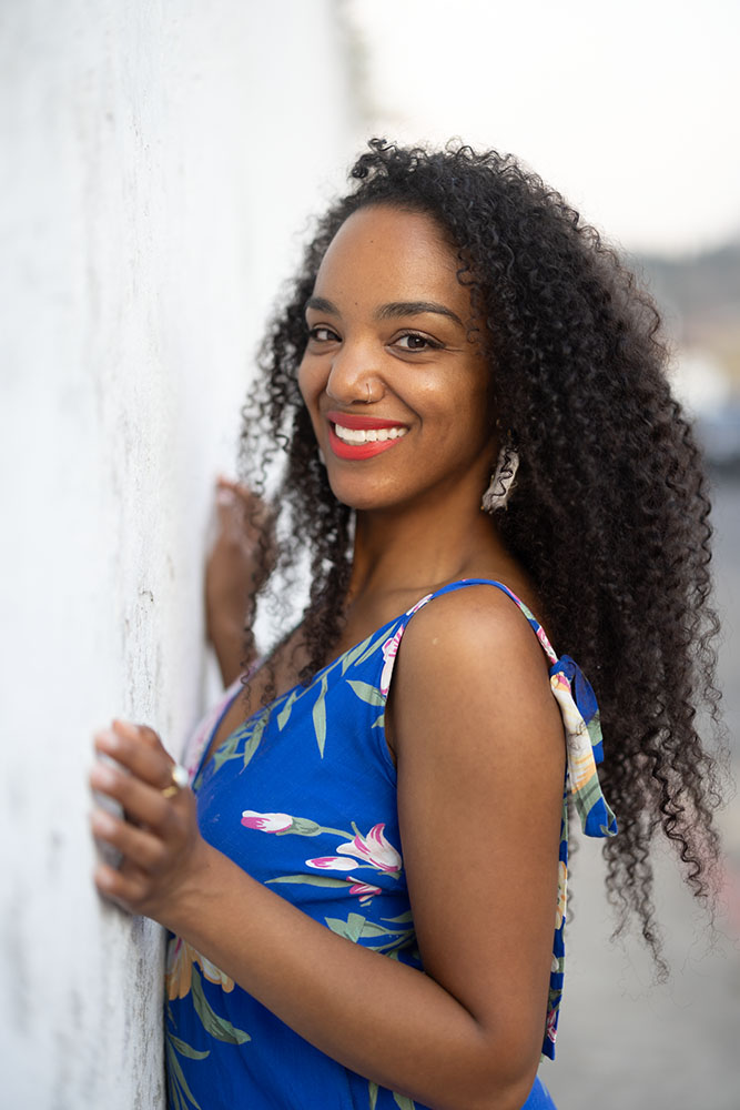 Nadalie Bardo It's All You Boo Founder leaning on a wall.