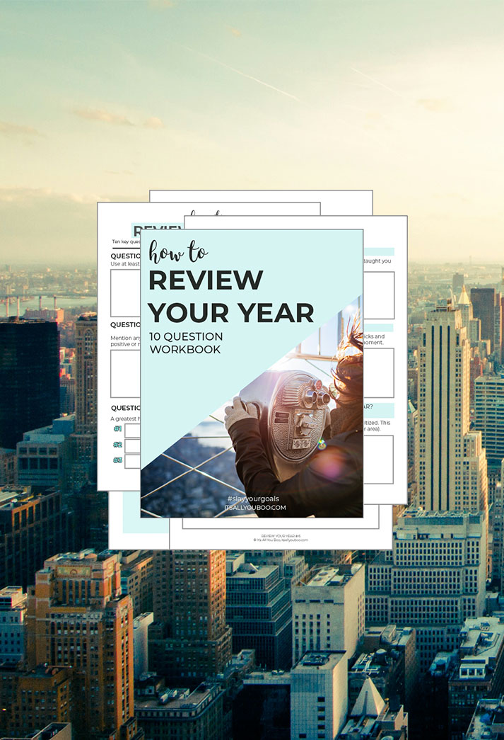 Review Your Year Workbook Preview in front of a skyline.