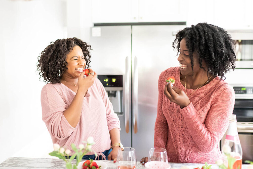 Friends Laughing and Eating in the Kitchen.