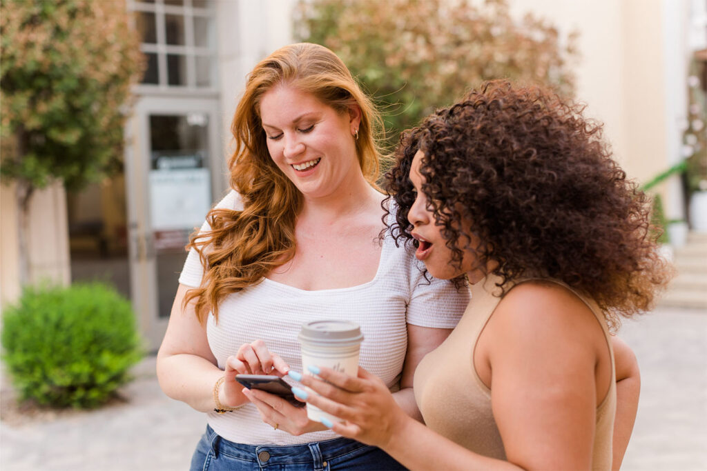 Friends Out Talking Looking At Phone.