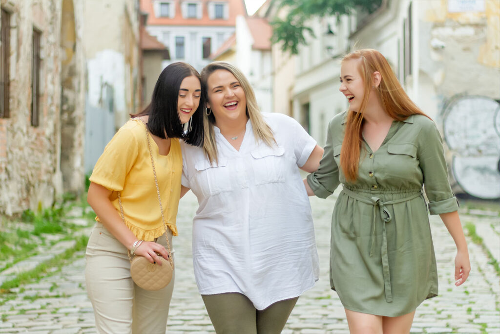 Friends Walking Outside Laughing. Showing what friendship is like.