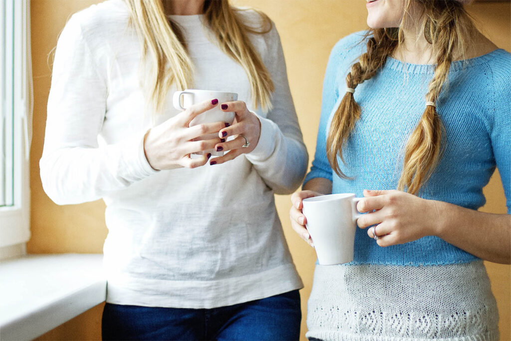 Two Friends Talking with Mugs. Illustrating friendship.