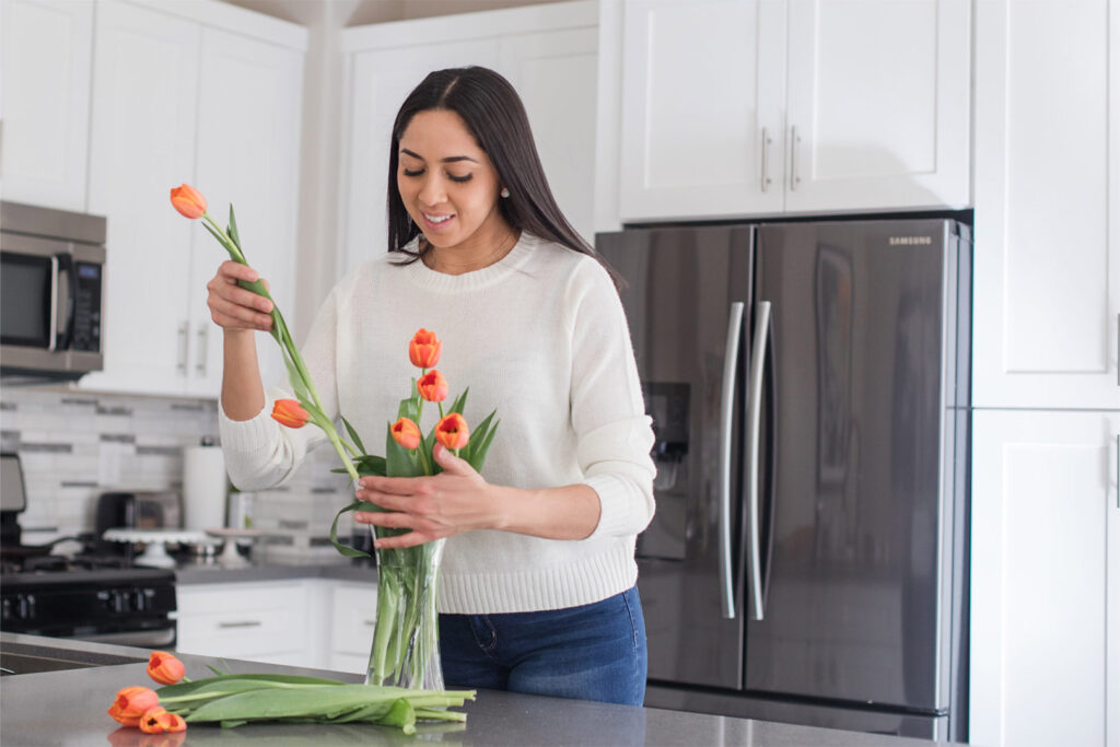 Woman Making a Tulip Bouquet in Kitchen. Showing what to do in spring.